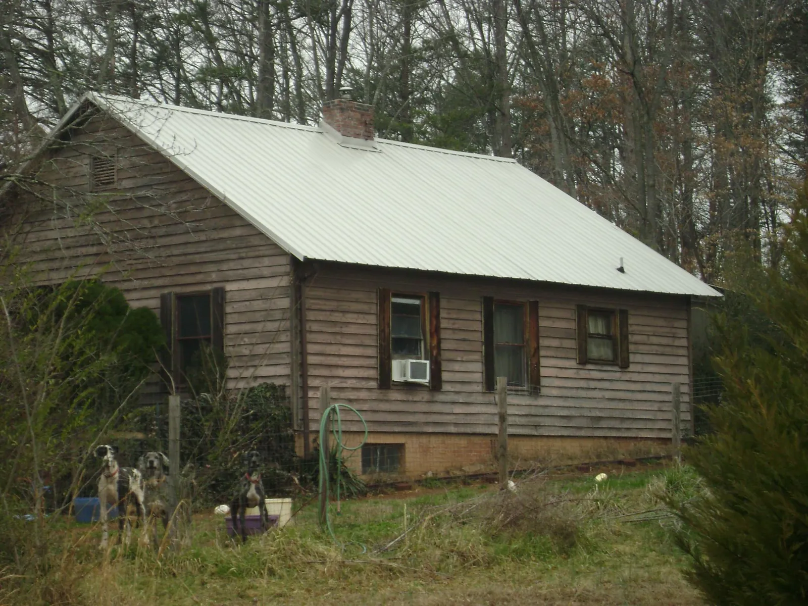 White metal roof on an old wood sided farmhouse, from a Metal Roof Installation job in North Haverhill